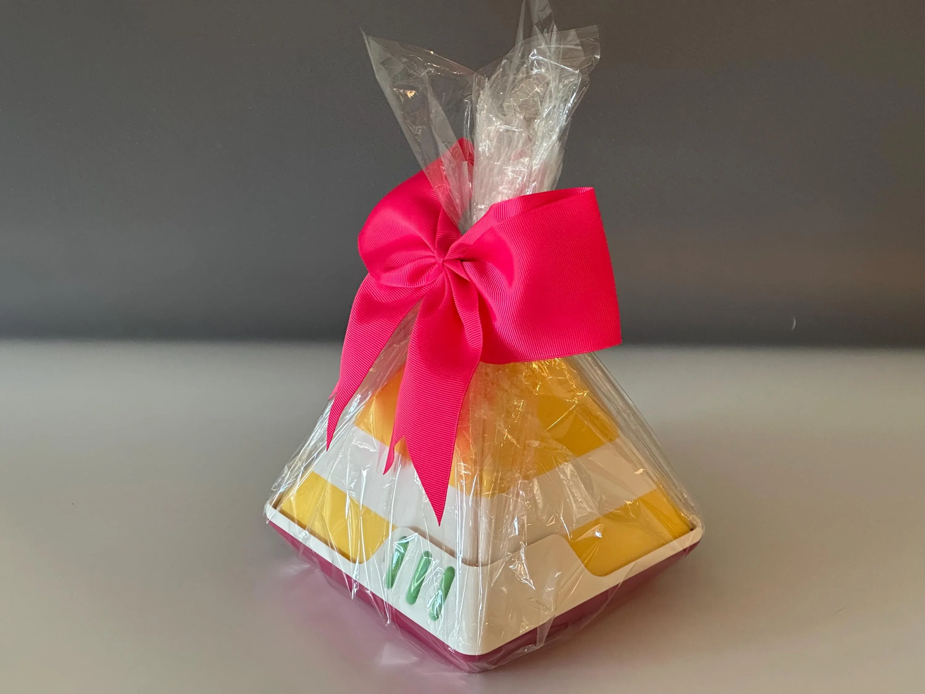 The XL gift box wrapped in cellophane and finished with a bright pink ribbon